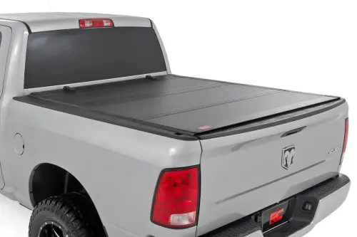 Rough Country - 49318650 | Rough Country Hard Tri-Fold Flip Up Bed Cover (2010-2018 Ram 1500 2WD/4WD | 2010-2024 Ram 2500 2WD/4WD | 6'4" Bed)